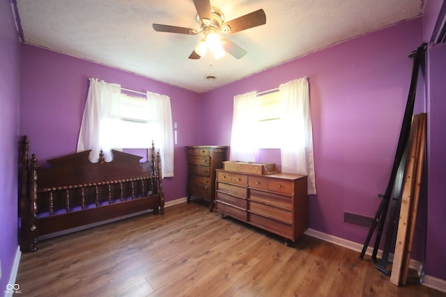 5041 Norcroft Dr, Indianapolis, IN 46221 - bedroom featuring baseboards, a ceiling fan, and light wood-type flooring