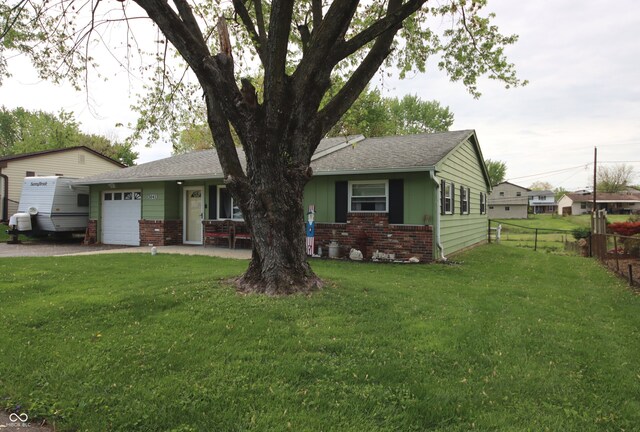 5041 Norcroft Dr, Indianapolis, IN 46221 - ranch-style home with a garage, a front lawn, fence, brick siding, and dirt driveway
