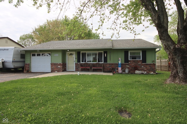 5041 Norcroft Dr, Indianapolis, IN 46221 - ranch-style house with brick siding, aphalt driveway, a front lawn, and a garage
