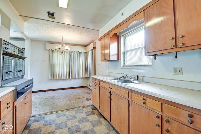 kitchen featuring an inviting chandelier, a sink, light countertops, light floors, and visible vents