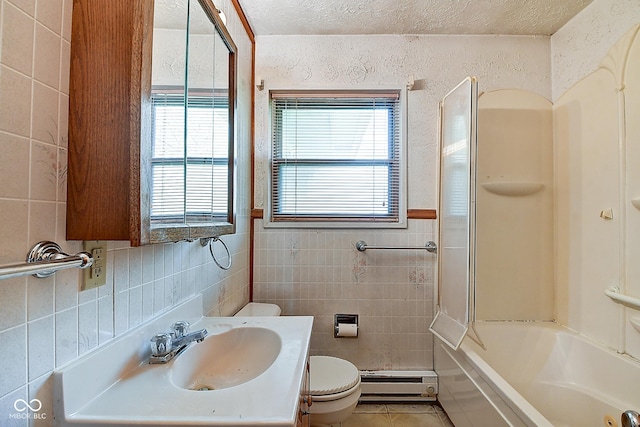 bathroom featuring toilet, tile walls, a wealth of natural light, and a baseboard radiator
