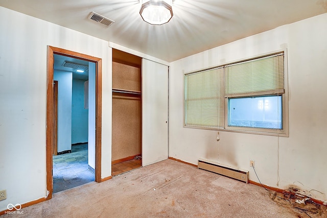 unfurnished bedroom featuring visible vents, carpet floors, a closet, baseboards, and baseboard heating