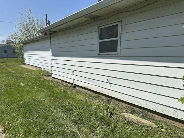view of property exterior with a lawn