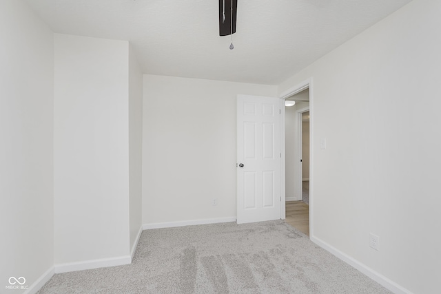 empty room with baseboards and carpet