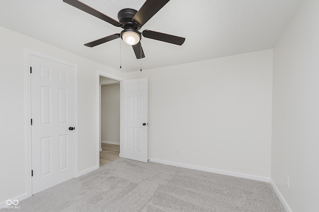 unfurnished bedroom with carpet floors, baseboards, and ceiling fan