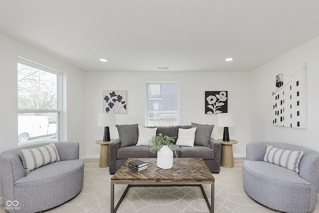 living room with recessed lighting, baseboards, visible vents, and plenty of natural light
