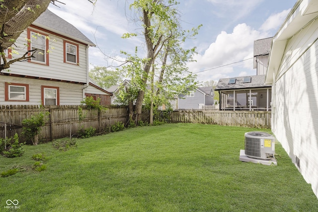 view of yard with a fenced backyard and central AC