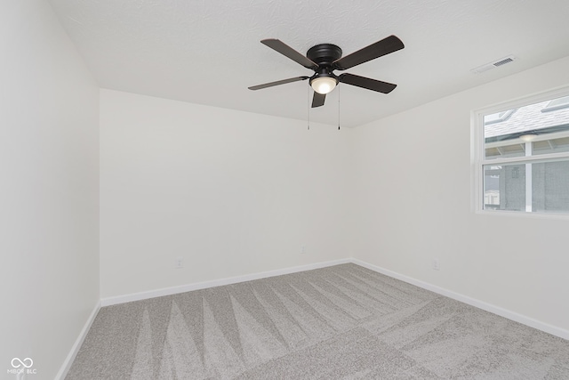 spare room with visible vents, a ceiling fan, carpet, and baseboards