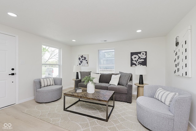 living room featuring light wood-type flooring, recessed lighting, and baseboards