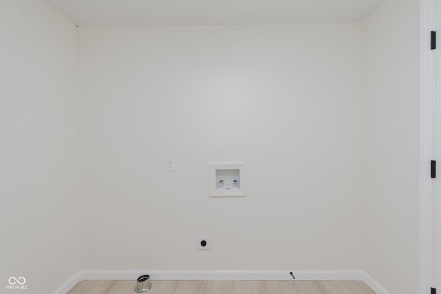 laundry area featuring washer hookup, baseboards, light wood finished floors, and electric dryer hookup
