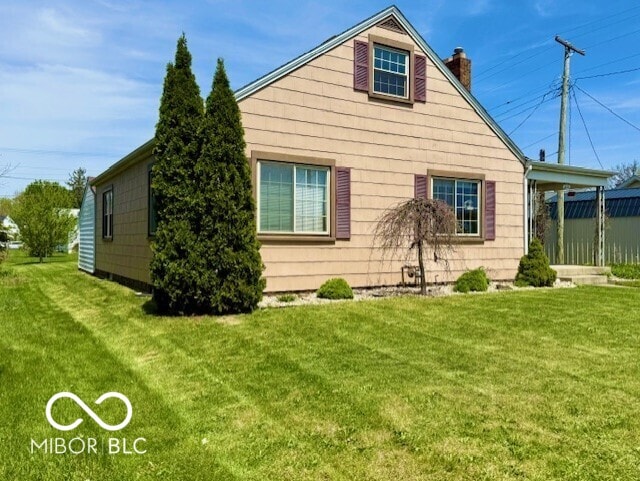 view of property exterior with a lawn and a chimney