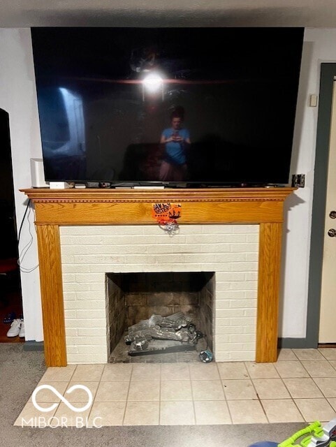 interior details featuring a brick fireplace
