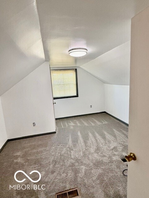 bonus room featuring carpet floors, baseboards, vaulted ceiling, and visible vents
