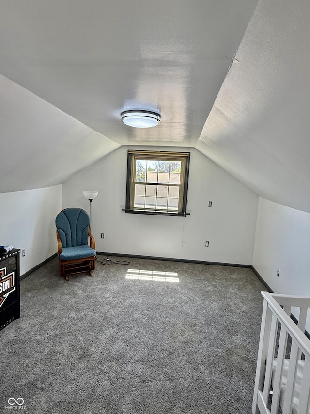 bonus room with carpet floors, baseboards, and lofted ceiling