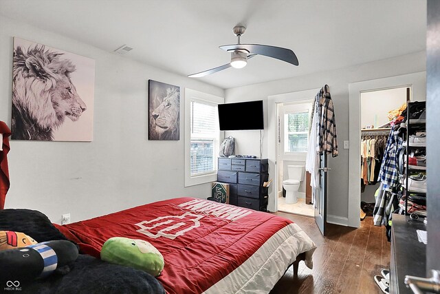 1641 Iowa St, Indianapolis, IN 46203 - bedroom featuring a spacious closet, hardwood / wood-style floors, connected bathroom, a closet, and ceiling fan