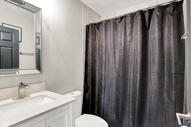 1641 Iowa St, Indianapolis, IN 46203 - bathroom with toilet, vanity, and a shower with curtain
