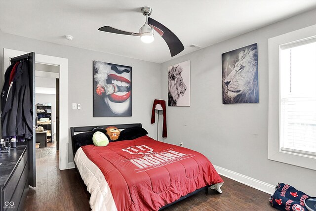 1641 Iowa St, Indianapolis, IN 46203 - bedroom with dark wood-type flooring, baseboards, and ceiling fan