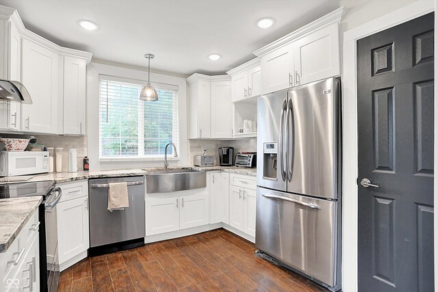 1641 Iowa St, Indianapolis, IN 46203 - kitchen featuring appliances with stainless steel finishes, a sink, white cabinets, decorative backsplash, and recessed lighting