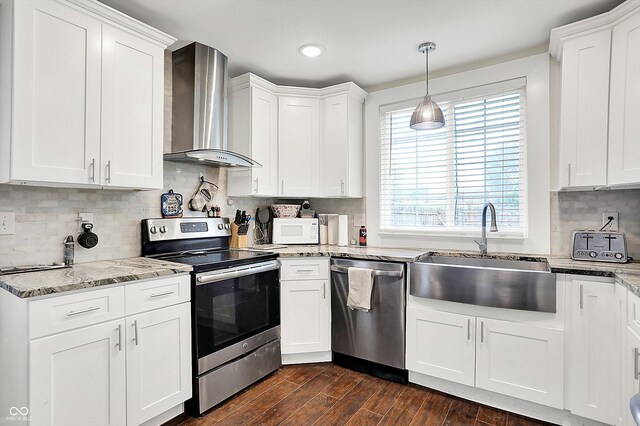 1641 Iowa St, Indianapolis, IN 46203 - kitchen featuring wall chimney exhaust hood, appliances with stainless steel finishes, a sink, plenty of natural light, and recessed lighting