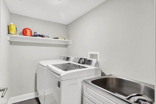 1641 Iowa St, Indianapolis, IN 46203 - washroom featuring independent washer and dryer, baseboards, wood finished floors, and cabinet space