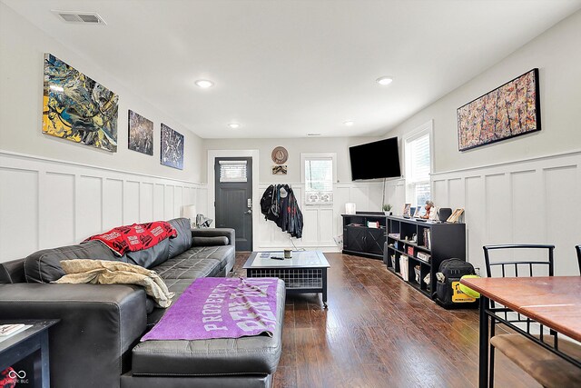 1641 Iowa St, Indianapolis, IN 46203 - living area with a decorative wall, wainscoting, dark wood-style flooring, and recessed lighting
