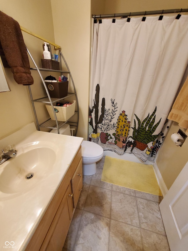 1050 Jefferson Ave, Indianapolis, IN 46201 - full bath with vanity, stone finish floor, toilet, and curtained shower