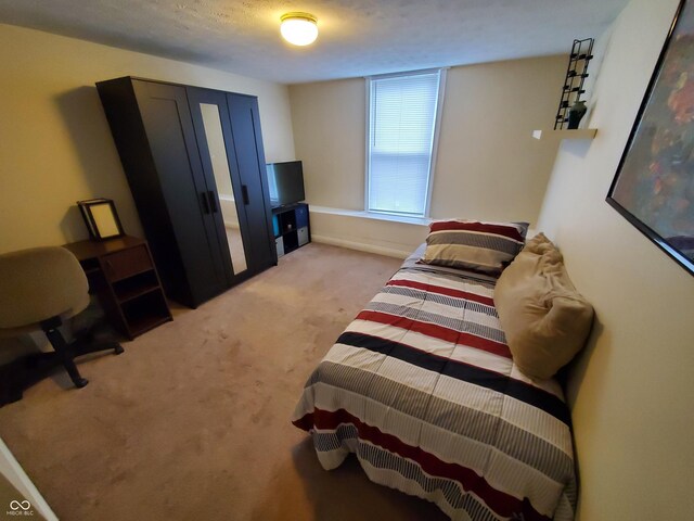 1050 Jefferson Ave, Indianapolis, IN 46201 - bedroom with baseboards and light colored carpet