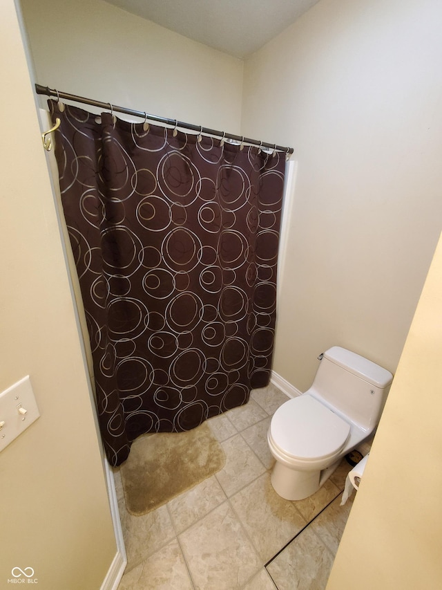 1050 Jefferson Ave, Indianapolis, IN 46201 - bathroom featuring toilet, a shower with shower curtain, and tile patterned flooring