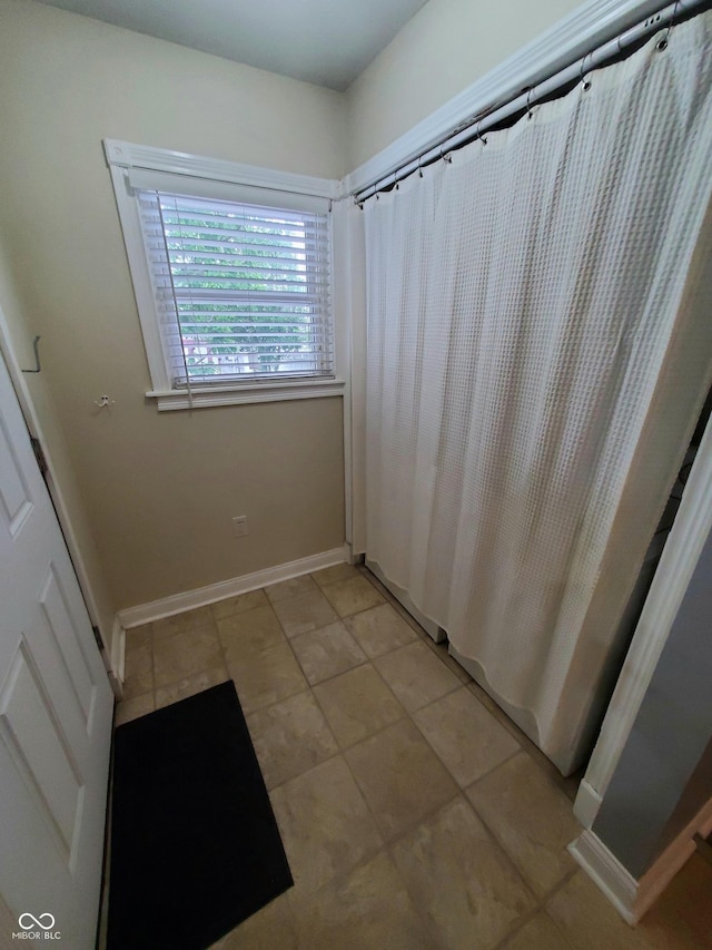 1050 Jefferson Ave, Indianapolis, IN 46201 - full bathroom with baseboards, tile patterned floors, and curtained shower