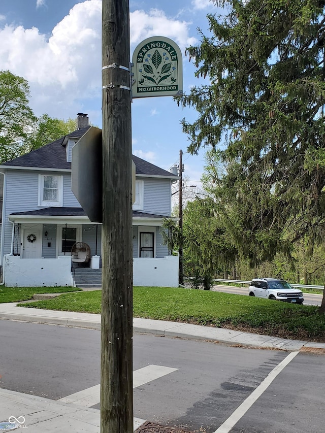 1050 Jefferson Ave, Indianapolis, IN 46201 - details featuring a shingled roof, a downspout, and a chimney
