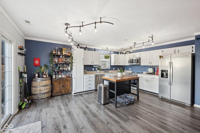 2116 Crimson Ln, Lebanon, IN 46052 - kitchen with visible vents, butcher block counters, wood finished floors, white cabinets, and stainless steel appliances
