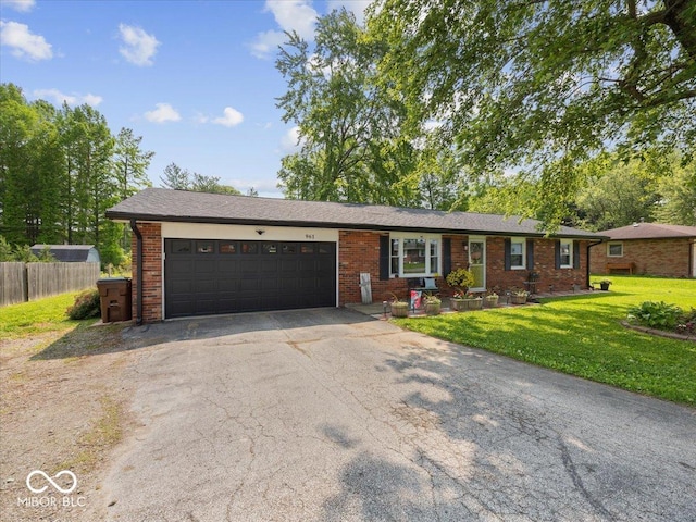 961 N Dellasburg Rd, Columbus, IN 47203 - ranch-style house featuring an attached garage, asphalt driveway, and brick siding