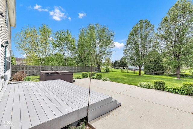 view of patio / terrace featuring a hot tub and a fenced backyard