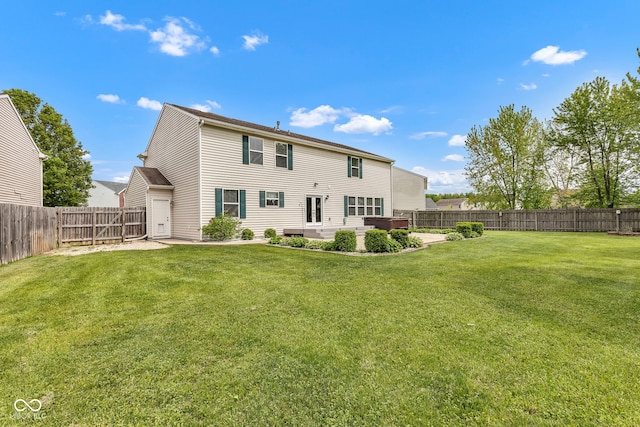 back of house with a patio, a lawn, and a fenced backyard