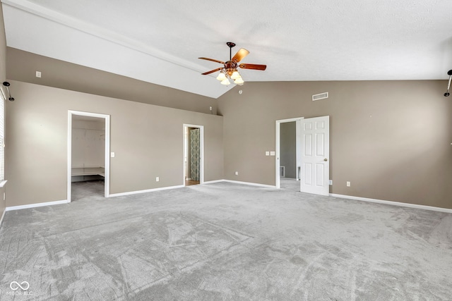 unfurnished room with carpet flooring, a ceiling fan, high vaulted ceiling, visible vents, and baseboards