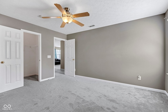 unfurnished bedroom featuring visible vents, baseboards, ceiling fan, and carpet floors