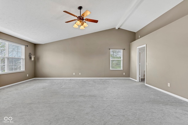 carpeted empty room with a wealth of natural light, baseboards, and a ceiling fan