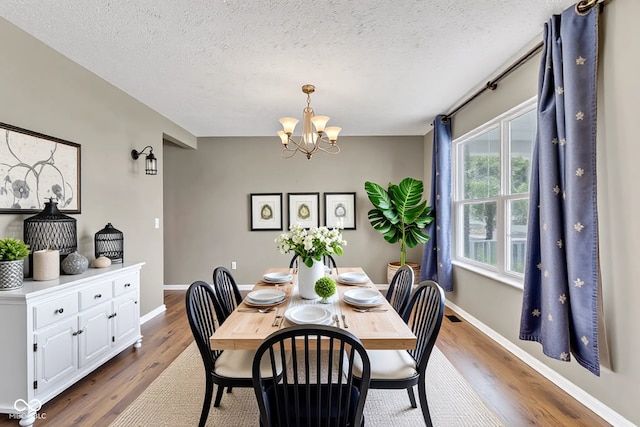3652 Newberry Rd, Plainfield, IN 46168 - dining room featuring a chandelier, wood finished floors, a textured ceiling, and baseboards