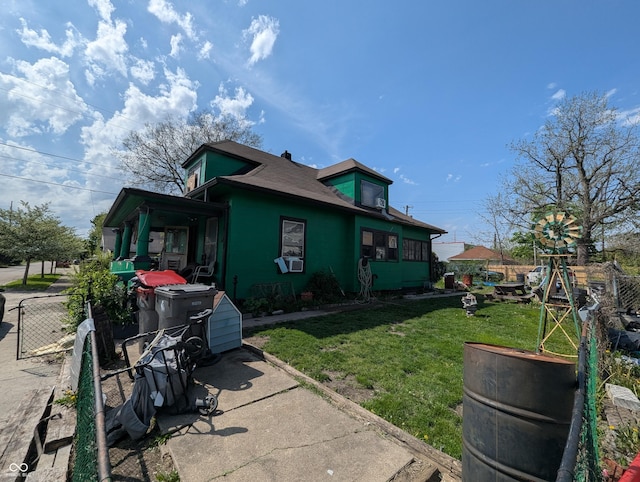 view of side of property with a lawn, fence, and cooling unit