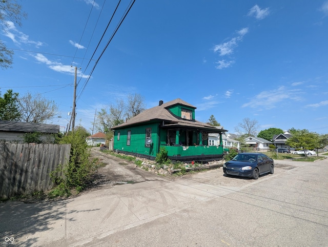 view of front of home featuring fence