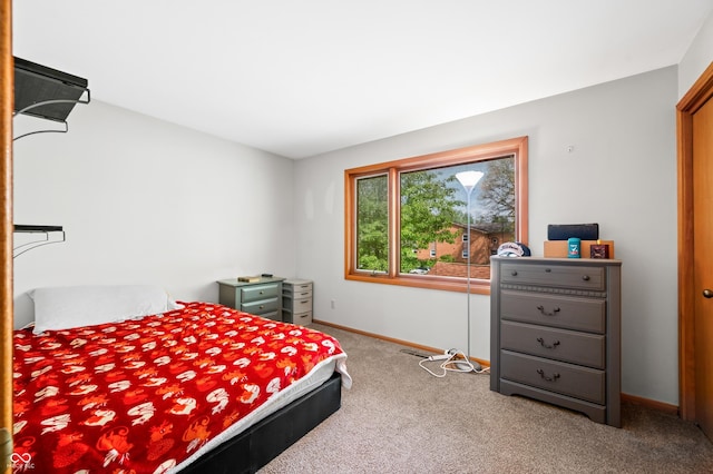bedroom featuring carpet floors and baseboards