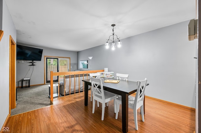 dining room featuring baseboards and wood finished floors