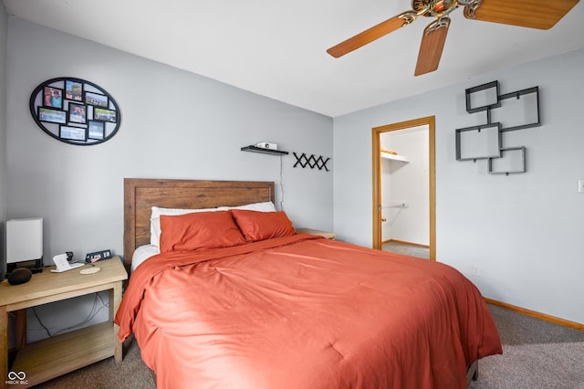 carpeted bedroom featuring baseboards and ceiling fan