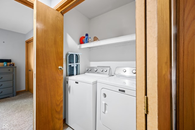 clothes washing area featuring laundry area, independent washer and dryer, and light carpet