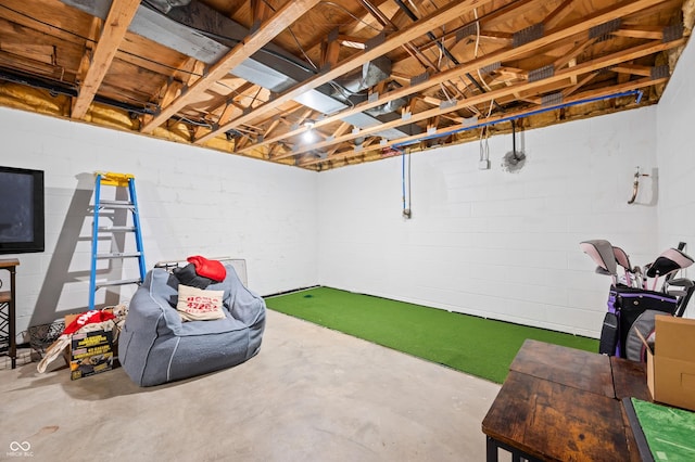 playroom featuring golf simulator and concrete floors