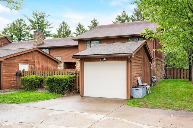 view of front of house featuring fence, a front lawn, a garage, a chimney, and concrete driveway