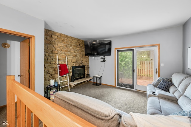 carpeted living area featuring a stone fireplace