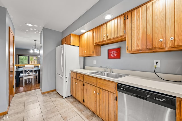 kitchen featuring light countertops, a sink, freestanding refrigerator, and dishwasher