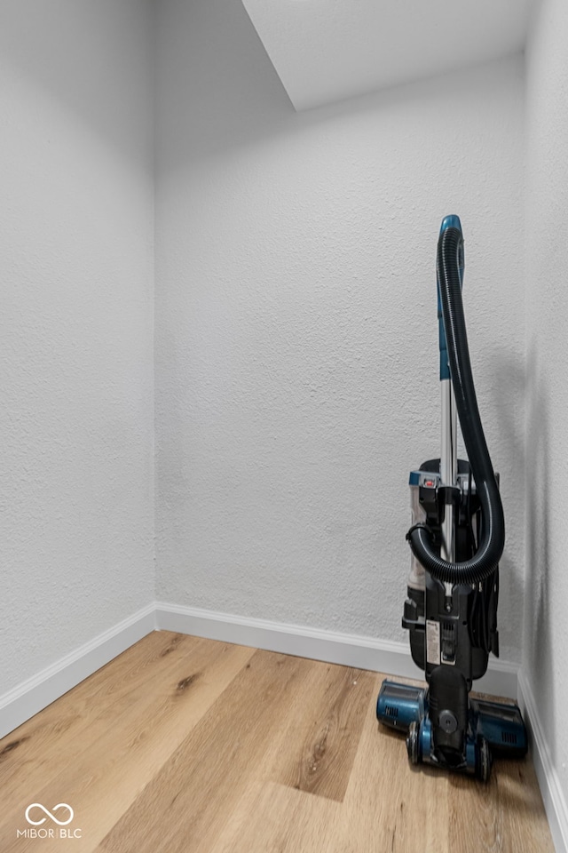 room details featuring baseboards and wood finished floors