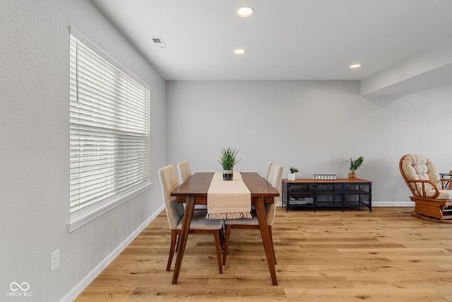 dining area with recessed lighting, baseboards, visible vents, and light wood finished floors